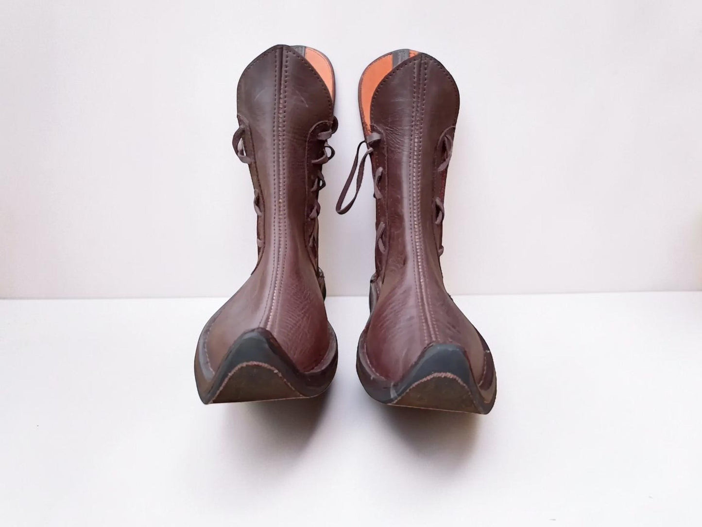 Handmade medieval leather boots with wrap laces and full-grain texture, ideal for LARP or SCA reenactment footwear.