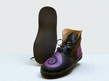 Black and purple handmade leather boot with spiral design, wrap laces, and full-grain leather sole for LARP or Renaissance faire.