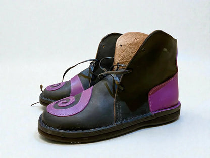 Handmade medieval leather boots with purple swirl accents, wrap laces, and full-grain leather texture for LARP or Renaissance faire.