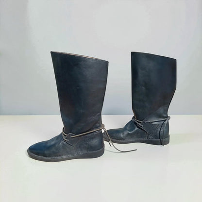 Handmade black medieval leather boots with wrap laces and full-grain texture, ideal for LARP or SCA reenactment.
