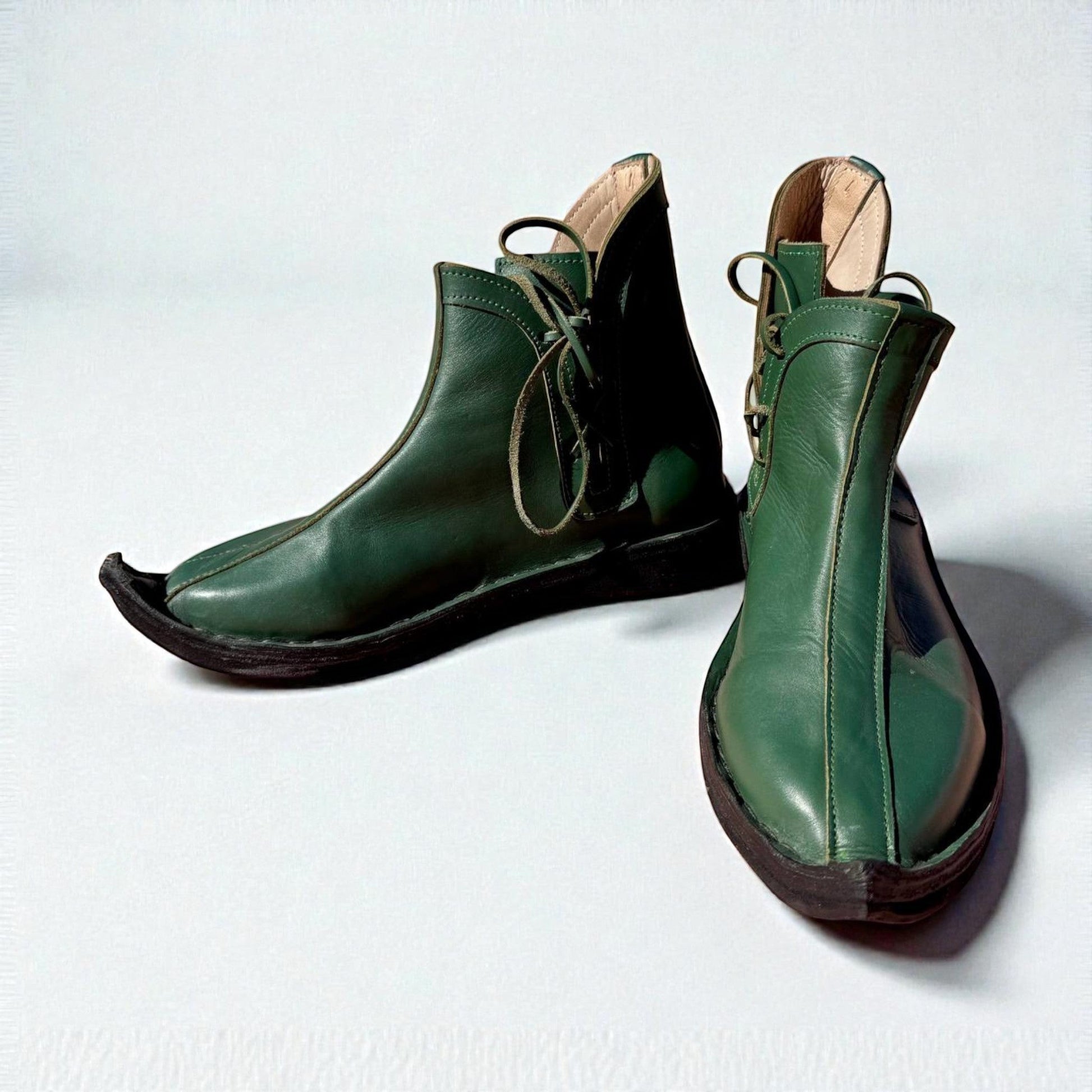Handmade green medieval leather boots with wrap laces and full-grain texture, ideal for LARP or Renaissance faire
