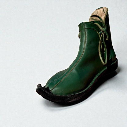 Handmade green medieval leather boot with wrap laces, full-grain texture, and pointed toe for LARP or Renaissance faire.