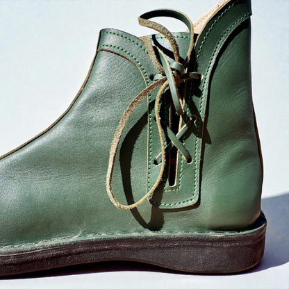 Olive green handmade leather boot with wrap laces and visible stitching, crafted for medieval or Viking LARP use.