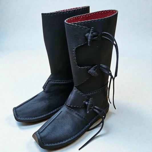 Black handmade medieval leather boots with wrap laces, red lining, and visible stitching, crafted for LARP and SCA reenactment.