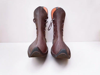 Handmade medieval leather boots with wrap laces and full-grain texture, ideal for LARP or SCA reenactment footwear.