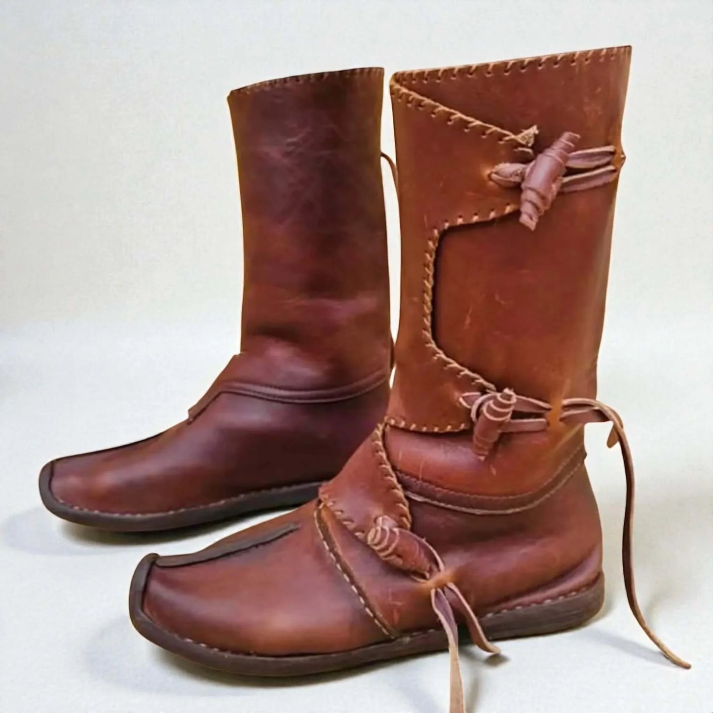 Handmade medieval leather boots with wrap laces and full-grain texture, ideal for LARP or SCA reenactment footwear.