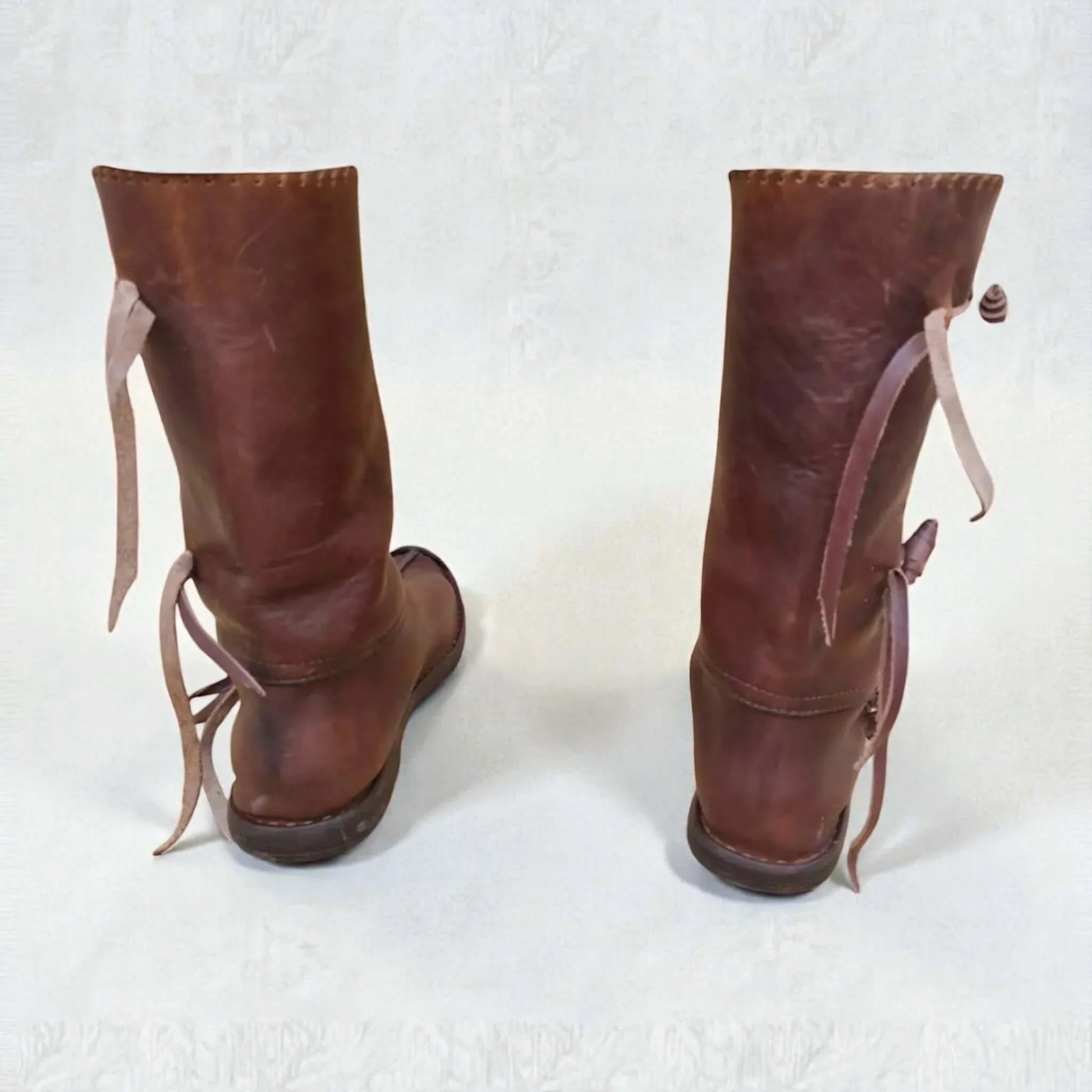 Handmade medieval leather boots with wrap laces and full-grain texture, ideal for LARP or Renaissance faire