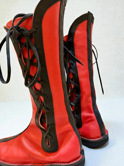 Vibrant red and black handmade leather boots with wrap laces, ideal for LARP or Renaissance faire events.