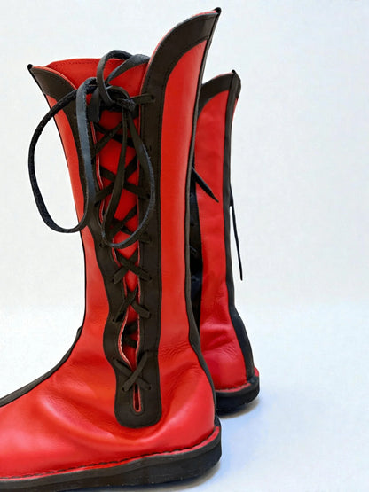 Vibrant red and black handmade medieval leather boots with wrap laces and full-grain texture, ideal for LARP or Renaissance fairs.