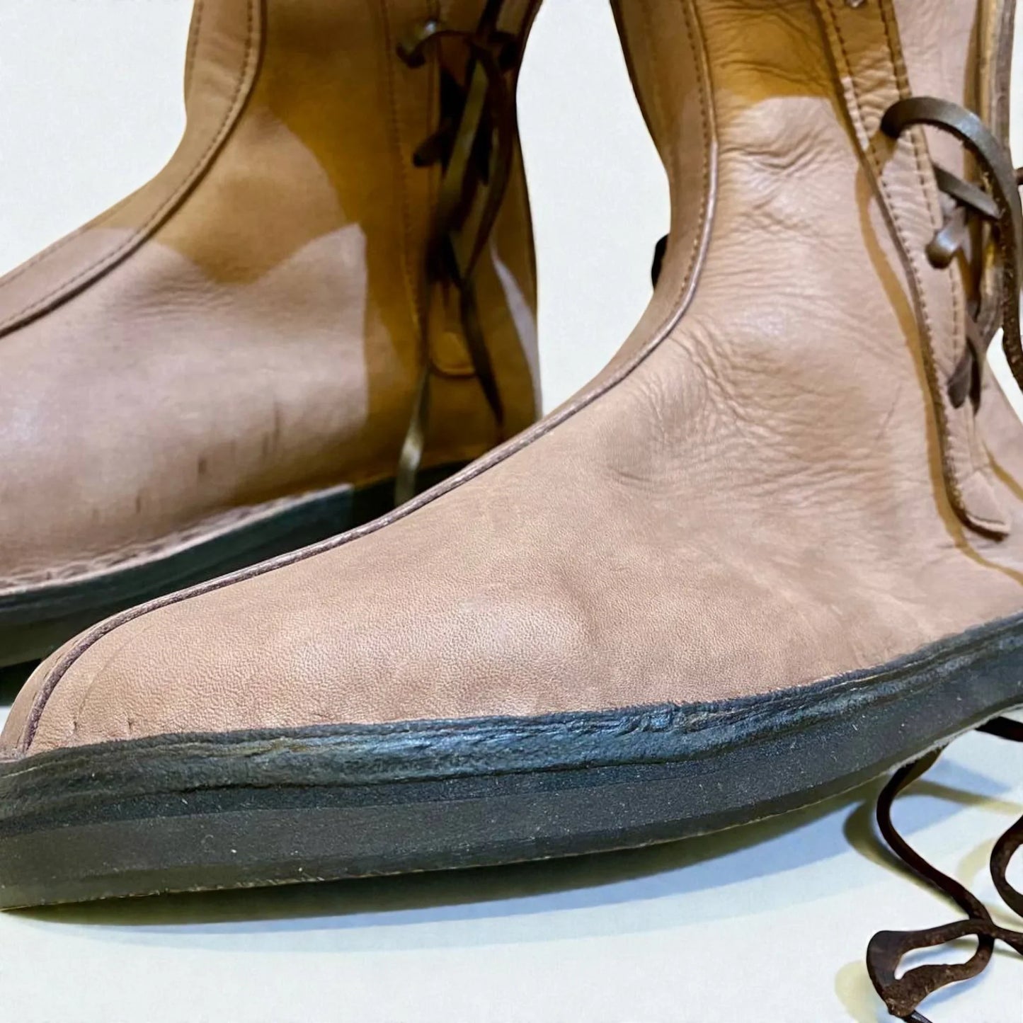 Tan full-grain leather boots with wrap laces and sturdy sole, ideal for medieval or Viking LARP and reenactment.