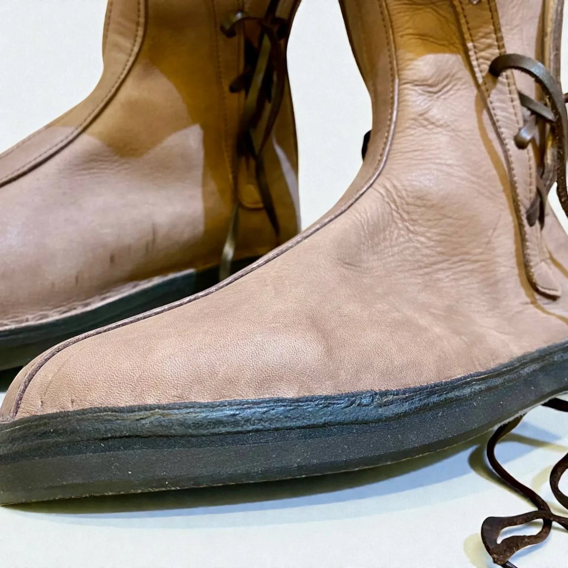 Tan full-grain leather boots with wrap laces and sturdy sole, ideal for medieval or Viking LARP and reenactment.