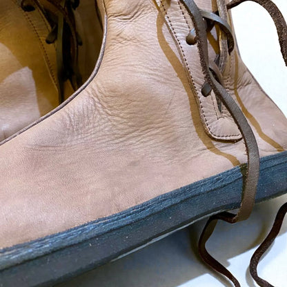 Tan full-grain leather boot with wrap laces and sturdy sole, ideal for medieval or Viking reenactment footwear.