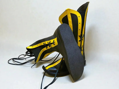 Black and gold handmade medieval leather boots with wrap laces and full-grain texture, ideal for LARP or Renaissance faire.
