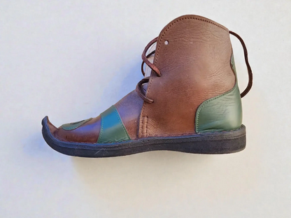 Handmade medieval leather boot with brown, green, and blue panels, wrap laces, and pointed toe for LARP or Renaissance faire.