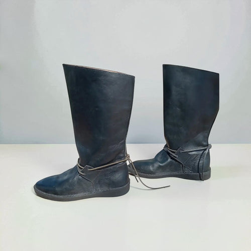 Handmade black medieval leather boots with wrap laces and full-grain texture, ideal for LARP or SCA reenactment.