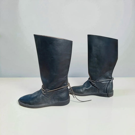 Handmade black medieval leather boots with wrap laces and full-grain texture, ideal for LARP or SCA reenactment.