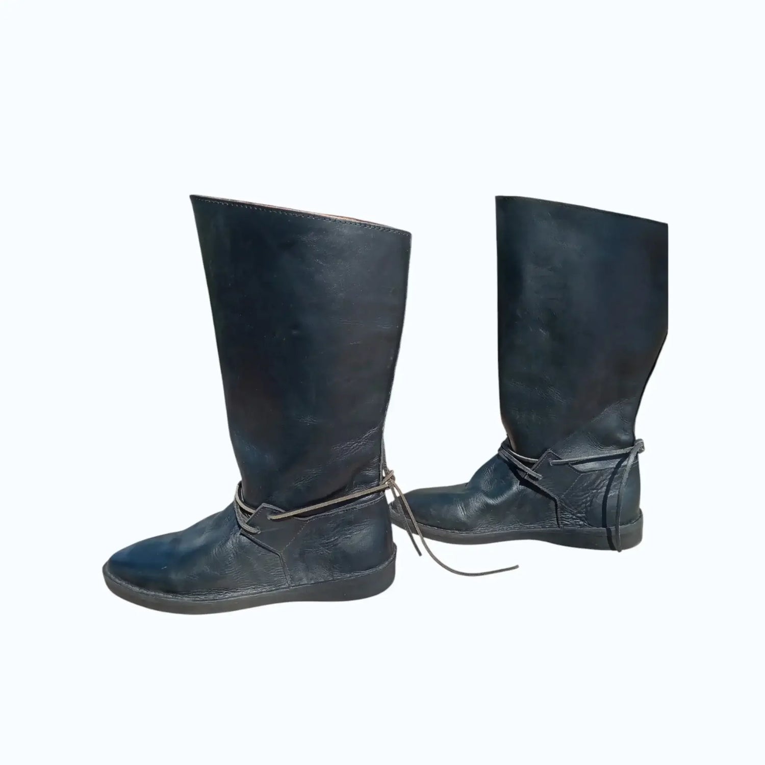 Black handmade medieval leather boots with wrap laces and full-grain texture, ideal for LARP or SCA reenactment.