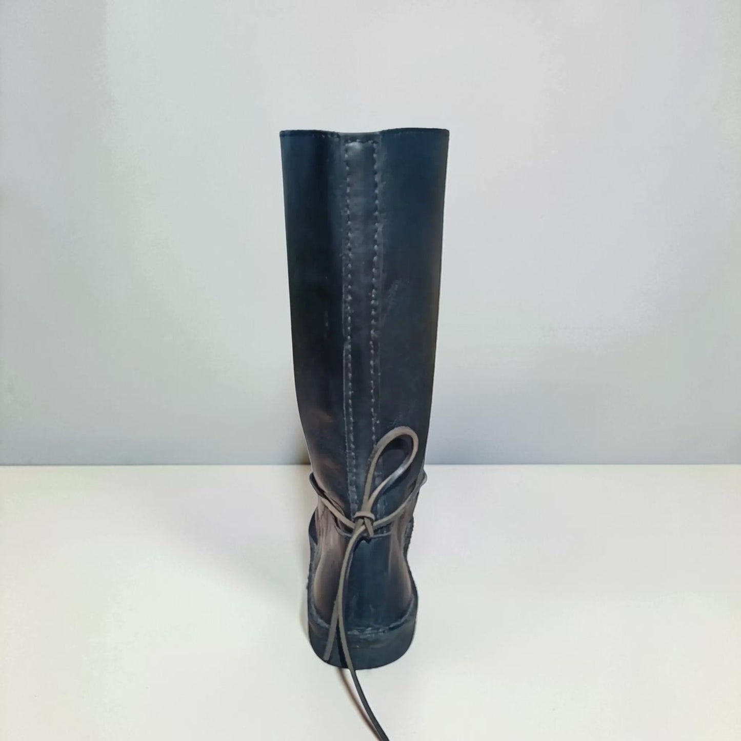 Dark medieval leather boot with wrap laces and visible stitching, handmade for LARP or SCA reenactment