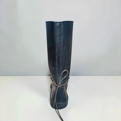 Dark medieval leather boot with wrap laces and visible stitching, handmade for LARP or SCA reenactment