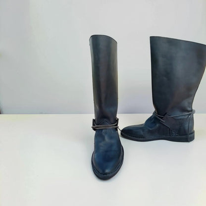 Handmade black medieval leather boots with wrap laces and full-grain texture, ideal for LARP or SCA reenactment.