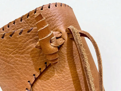 Close-up of handmade medieval leather boot with full-grain texture, wrap laces, and detailed stitching for LARP or SCA reenactment.