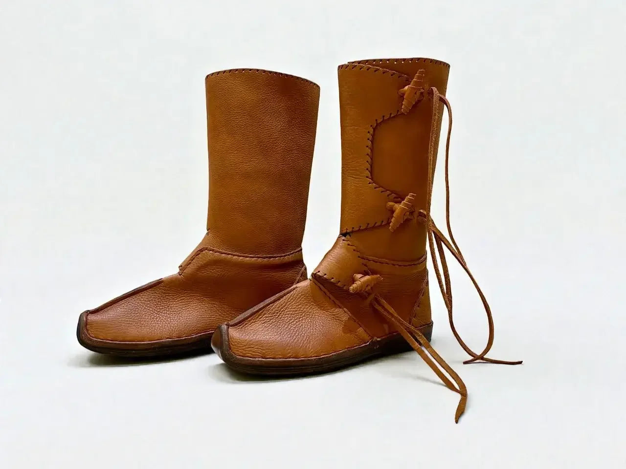 Handmade medieval leather boots with wrap laces and full-grain texture, ideal for LARP or SCA reenactment footwear.