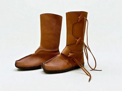 Handmade medieval leather boots with wrap laces and full-grain texture, ideal for LARP or SCA reenactment footwear.