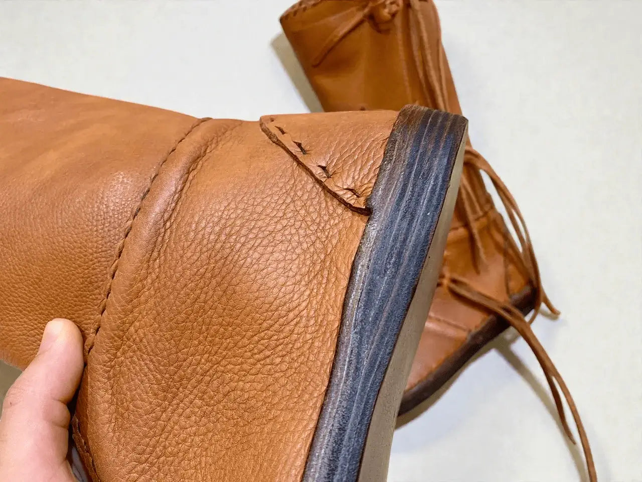 Handmade medieval leather boot with full-grain texture, wrap laces, and sturdy sole detail