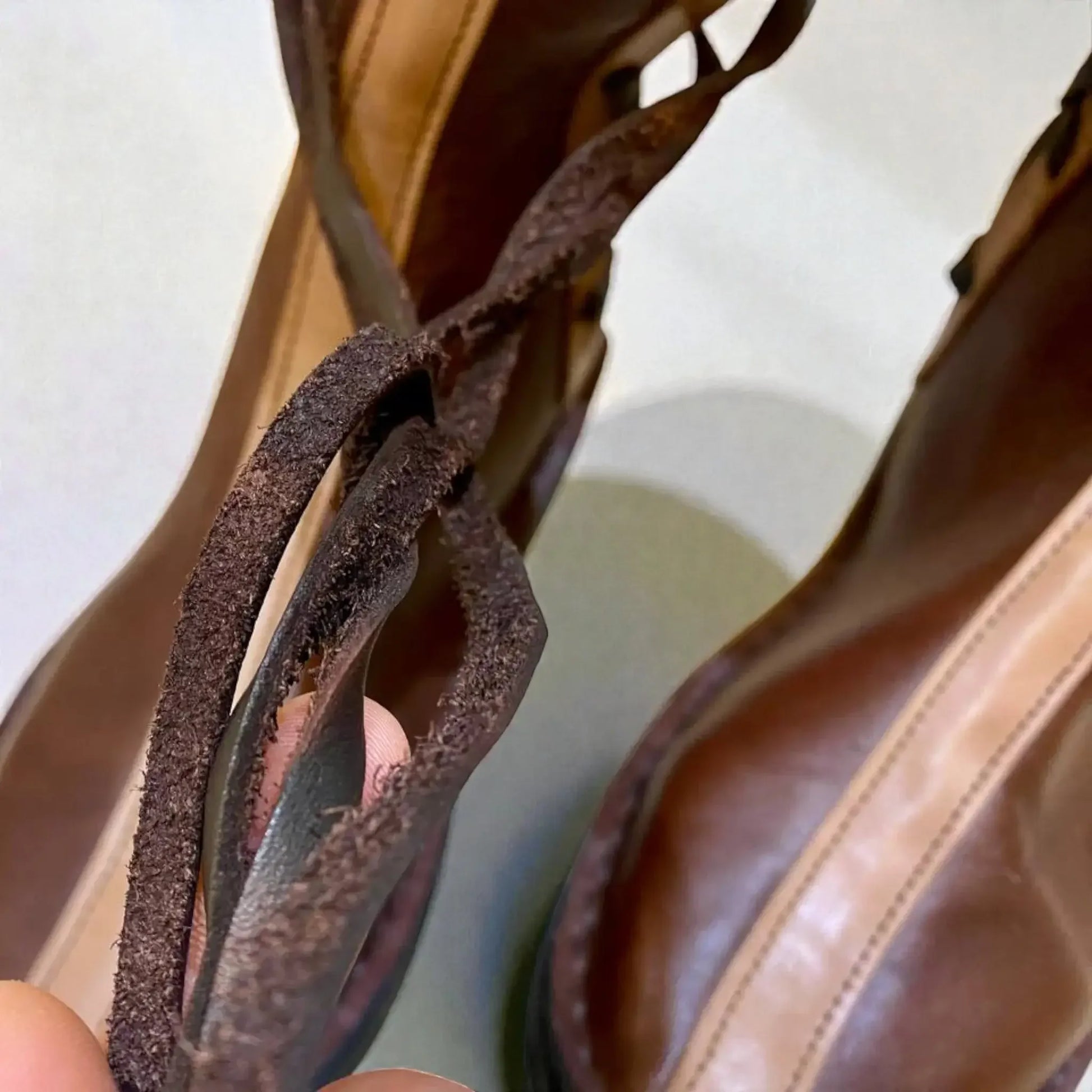 Close-up of handmade medieval leather boots showing full-grain texture, wrap laces, and sturdy stitching for LARP or SCA use.
