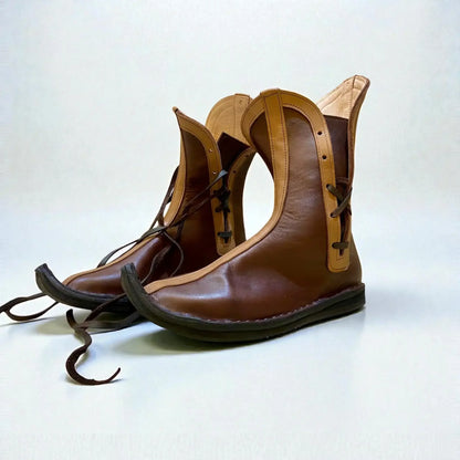 Handmade medieval leather boots with wrap laces and full-grain texture, ideal for LARP or Renaissance faire
