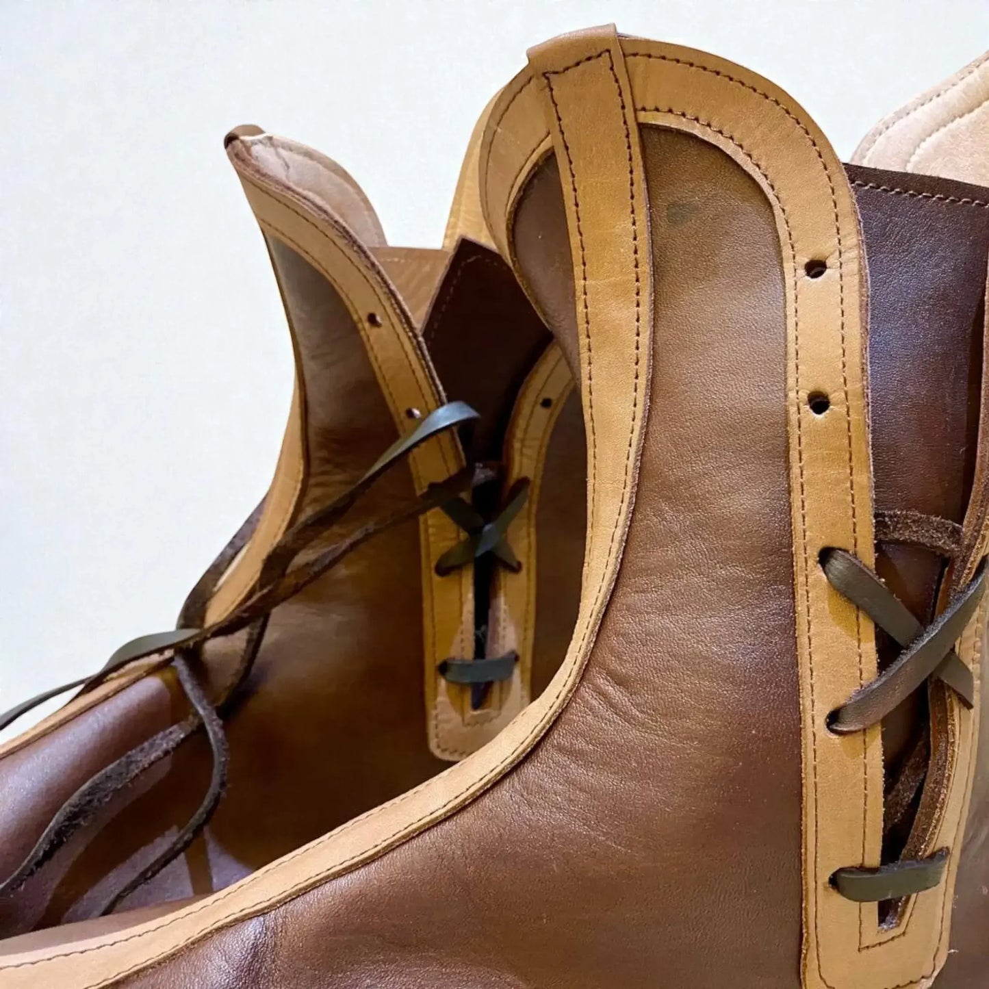 Handmade medieval leather boots with wrap laces and visible stitching, crafted from full-grain leather for LARP and reenactment.