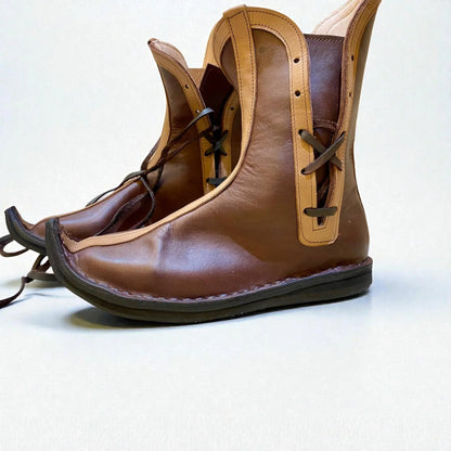 Handmade medieval leather boots with wrap laces, full-grain texture, and sturdy sole for LARP or SCA reenactment.