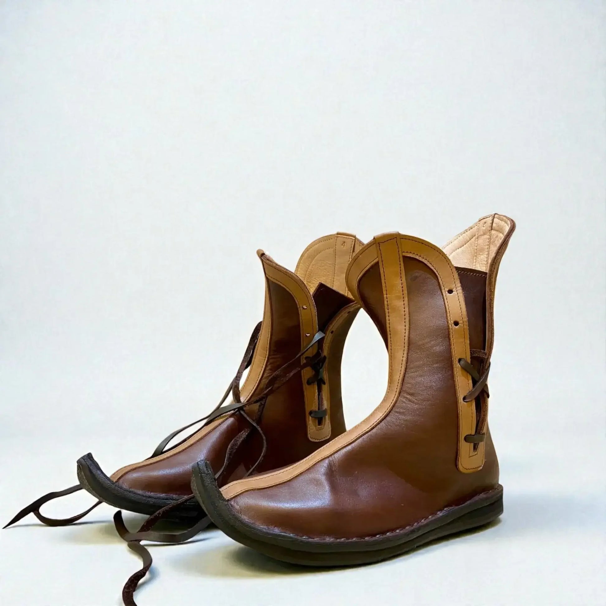 Handmade medieval leather boots with wrap laces and full-grain texture, ideal for LARP or Renaissance faire